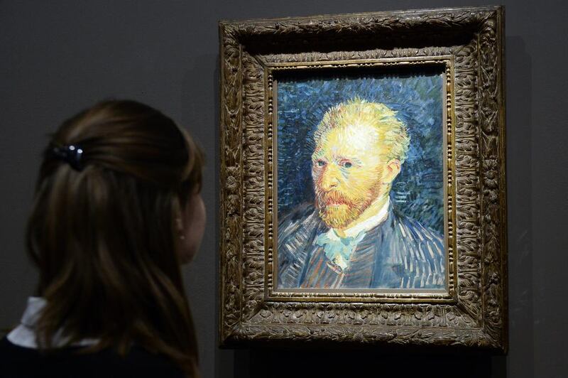A visitor looks at a self-portrait by Vincent Van Gogh. The Dutch artist's work will grace the walls of Louvre Abu Dhabi. Bertrand Guay / AFP