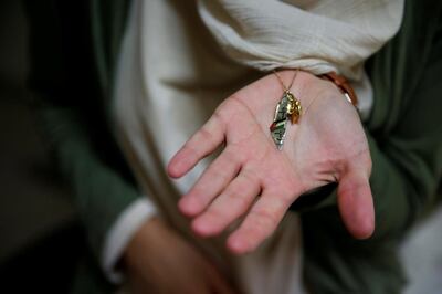 FILE PHOTO: Arab-Israeli poet Dareen Tatour, 35, holds a map-shaped necklace charm with a Palestinian flag and "Palestine" written in Arabic during an interview with Reuters at her house in Reineh, northern Israel September 26, 2017. Picture taken September 26, 2017. REUTERS/Ammar Awad/File Photo