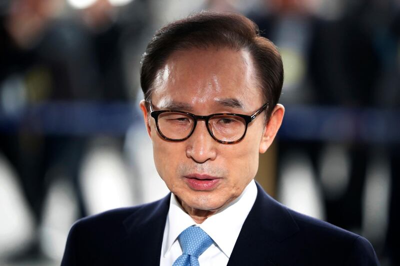 FILE - In this March 14, 2018, file photo, former South Korean President Lee Myung-bak arrives for questioning over bribery allegations at the Seoul Central District Prosecutors' Office in Seoul, South Korea.  A South Korean court has sentenced former President Lee to 15 years in prison over a slew of corruption charges. The Seoul Central District Court issued the sentence on Friday, Oct. 5,  after convicting Lee of bribery, embezzlement and other charges.(Kim Hong-Ji/Pool Photo via AP, File)