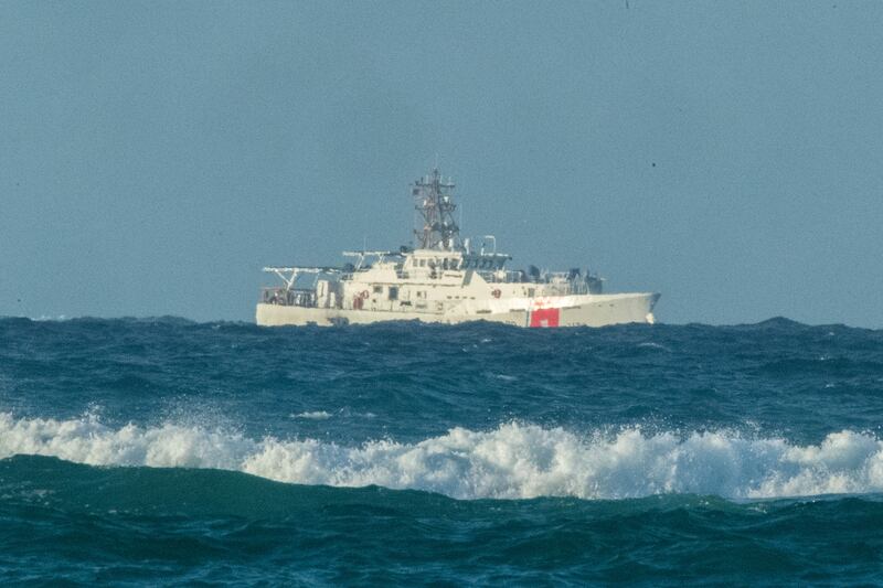 A US coastguard vessel patrols the area of debris from a 737 cargo plane that crashed into the sea off Honolulu, Hawaii on July 2.