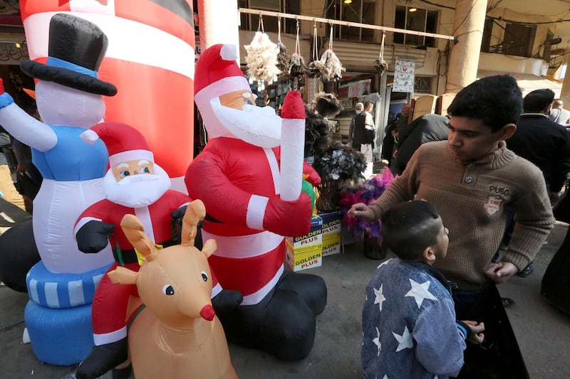 Iraqis check Christmas' decorations for sale at Al Rasheed Street in the capital Baghdad. AFP