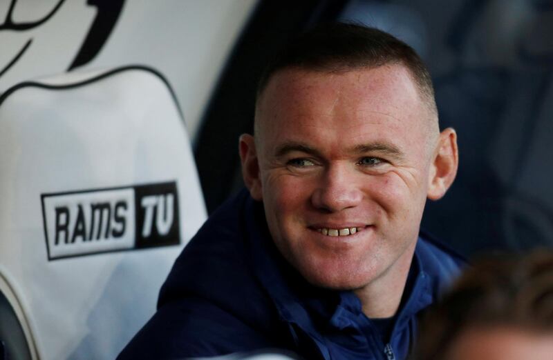 Wayne Rooney watches the Derby v QPR match from the dugout. Reuters