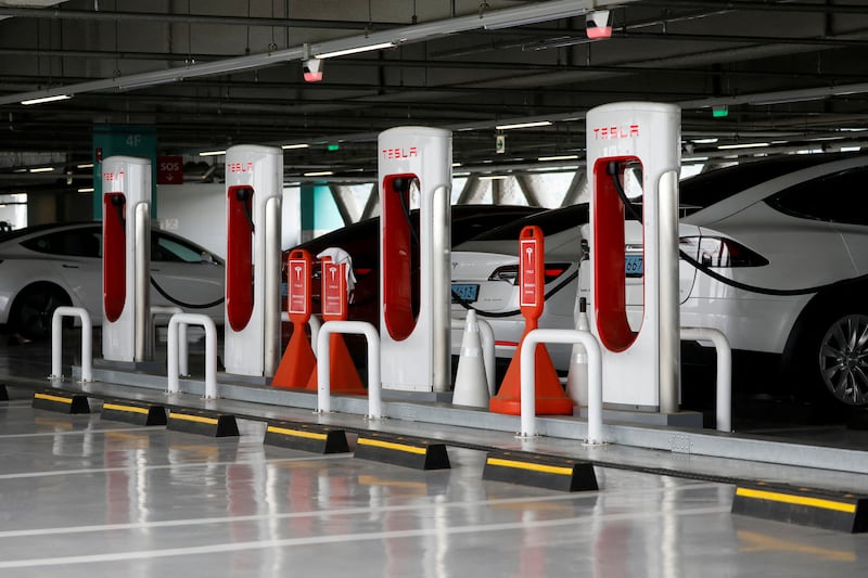 Tesla electric vehicles are charged at a Tesla Supercharger charging station in South Korea. Goldman Sachs forecasts sales of EVs to grow by 32 per cent annually this decade. Reuters