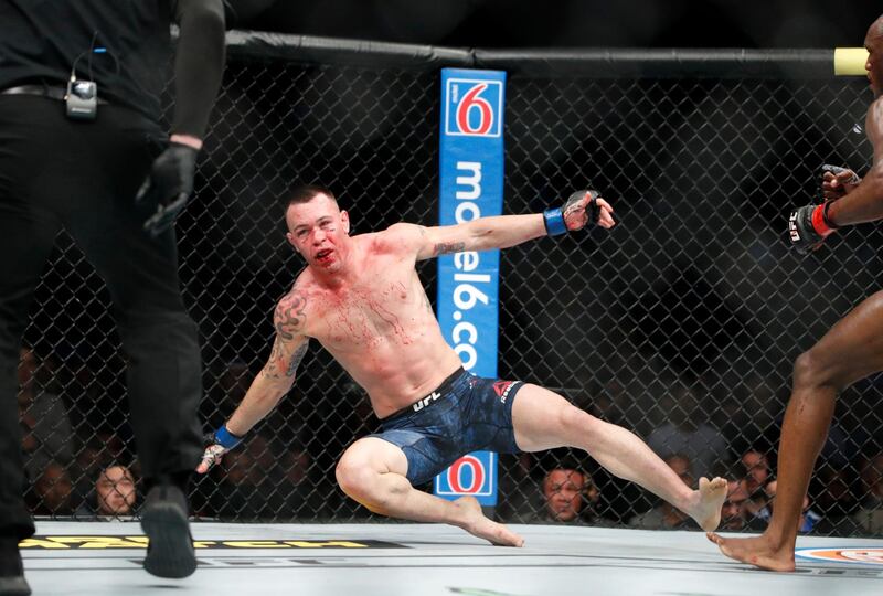 Kamaru Usman knocks Colby Covington to the floor in their mixed martial arts welterweight championship bout. AP