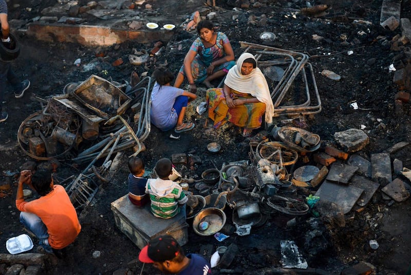 Slum dwellers look for their belongings after a fire broke out in Amritsar, India. AFP