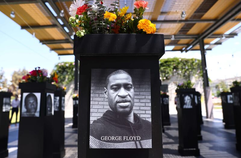 A photograph of George Floyd is displayed along with other photographs at the 'Say Their Names' memorial exhibit in San Diego, California.  The new resolution says that despite efforts to combat it, instances and various forms of racism remain widespread. Getty Images