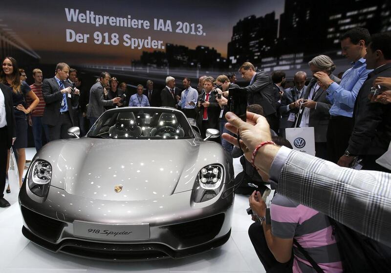 People take pictures of the new Porsche 918 Spyder hybrid car during a  preview day at the Frankfurt Motor Show. Wolfgang Rattay / Reuters

 