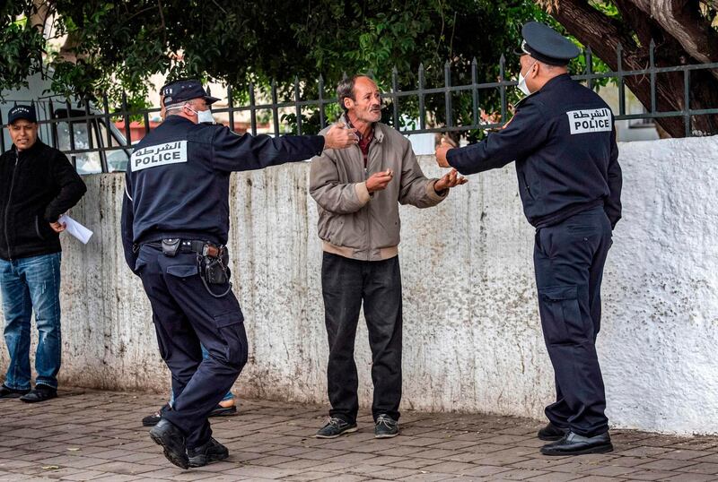 Policemen instruct a man to return home in Morocco's capital Rabat. AFP