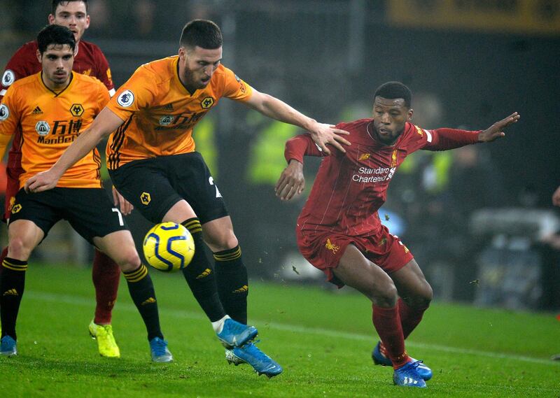 Liverpool's Georginio Wijnaldum, right, vies for the ball at Molineux Stadium. EPA