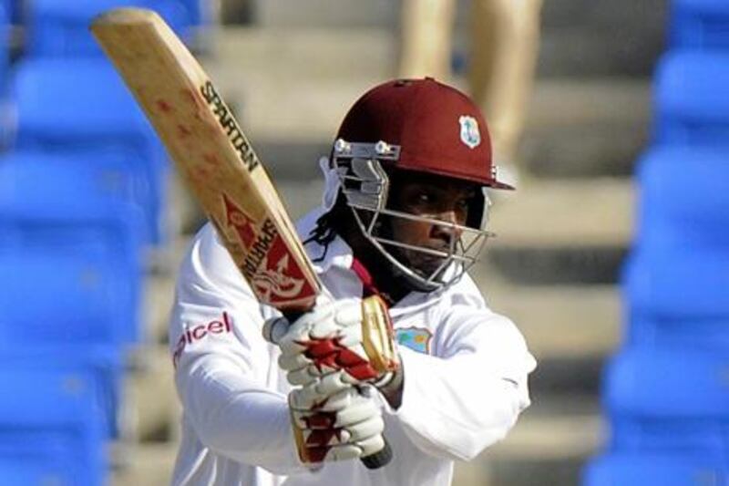 West Indies batsman Chris Gayle put on an unbeaten half-century in the first day against Zimbabwe.