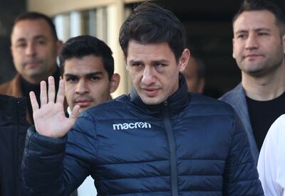 Turkish football referee Umut Meler waves as he leaves the hospital where he was treated in Ankara, on December 13. AFP