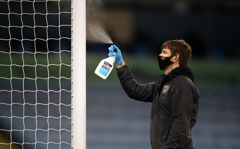 A member of ground staff sanitises a goal post during the Premier League match between Manchester City and Arsenal at Etihad Stadium in Manchester. Getty Images