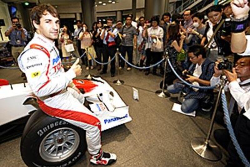 Toyota's Timo Glock, who came second in the Singapore Grand Prix, gives a thumbs up during a press conference for the upcoming Japanese Grand Prix at the company's Tokyo showroom.