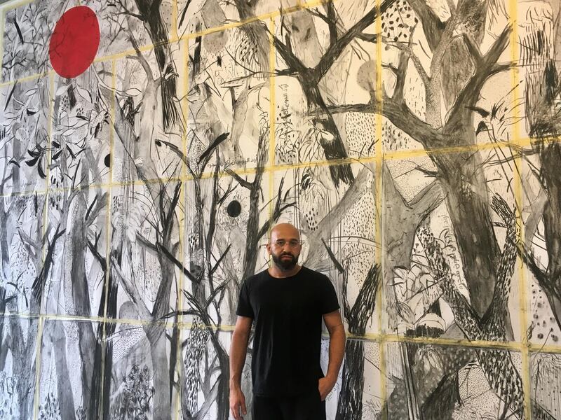 Lebanese artist Abed Al Kadiri standing in front of one of his new murals, part of a new project called Today I Would Like to Be a Tree. Robert McKelvey