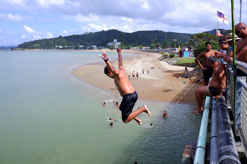 Children jump off the bridge in Waitangi, New Zealand. Getty Images