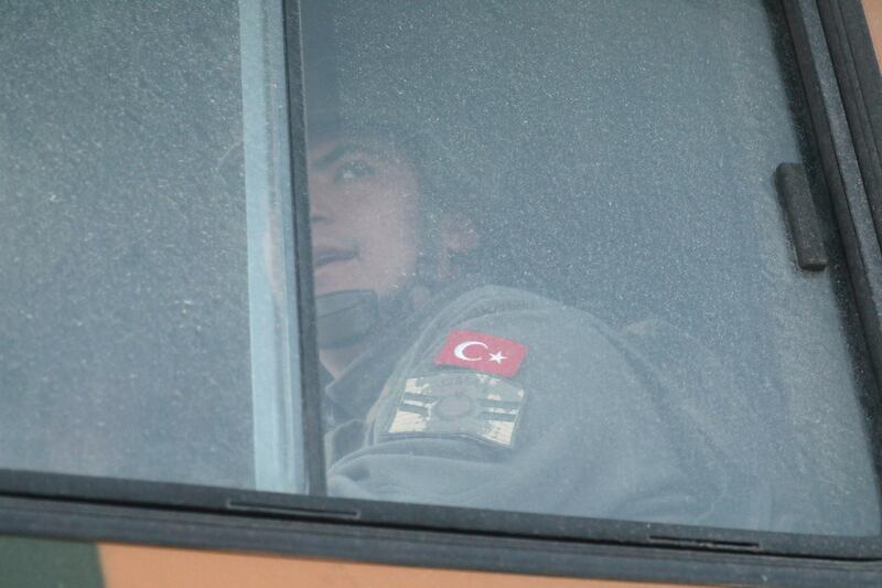 A Turkish military personnel looks out the window of a military vehicle as it enters the Bal al-Halwa crossing at the Syrian-Turkish border, in Idlib governorate, Syria. REUTERS