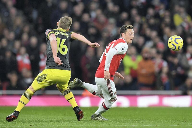 Arsenal's German midfielder Mesut Ozil (R) vies with Southampton's English midfielder James Ward-Prowse (L) during the English Premier League football match between Arsenal and Southampton at the Emirates Stadium in London on November 23, 2019. (Photo by Daniel LEAL-OLIVAS / AFP) / RESTRICTED TO EDITORIAL USE. No use with unauthorized audio, video, data, fixture lists, club/league logos or 'live' services. Online in-match use limited to 120 images. An additional 40 images may be used in extra time. No video emulation. Social media in-match use limited to 120 images. An additional 40 images may be used in extra time. No use in betting publications, games or single club/league/player publications. / 