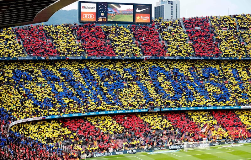 Barcelona fans create a mosaic reading 'champions!' in Catalan before the match. Pau Barrena / AFP
