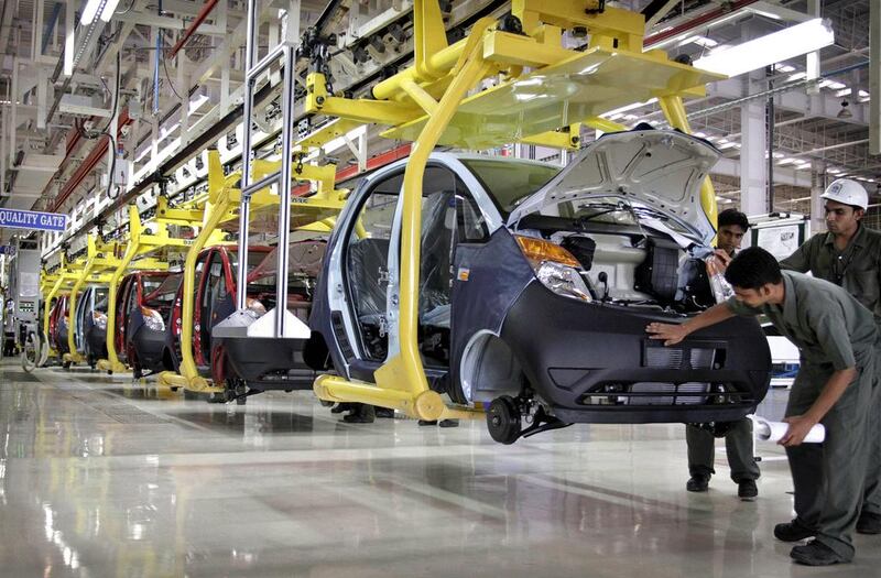 Employees of Tata Motors work on the assembly line of the super-cheap Nano compact car in Sanand, about 40 kilometres from Ahmadabad. Ajit Solanki / AP Photo