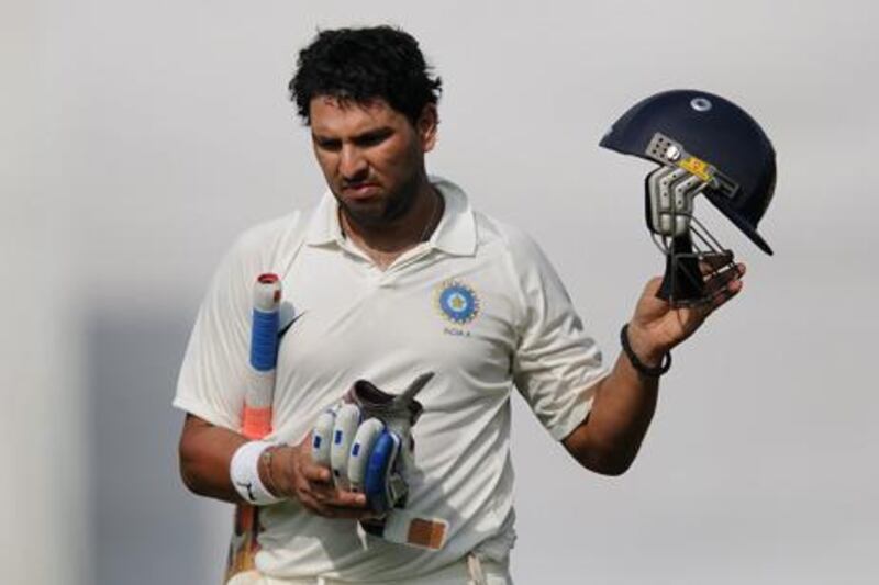 Indian cricketer Yuvraj Singh walks back to the pavilion during his appearance for the India A side against England