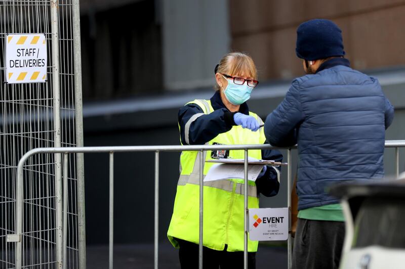 A security guard takes a delivery outside the Rydges Hotel which is being used as a quarantine hotel in Auckland, New Zealand. Getty Images