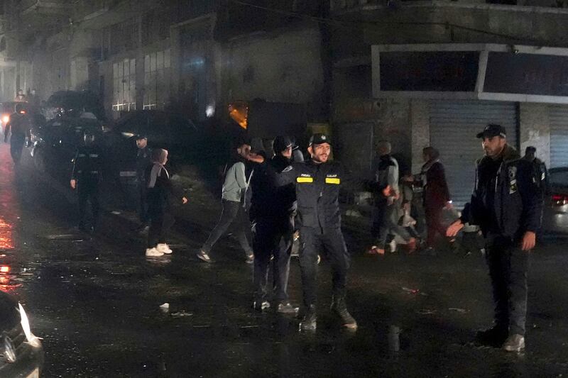 Police secure the scene. The apartment was on the top floor of a three-storey building.  AP Photo