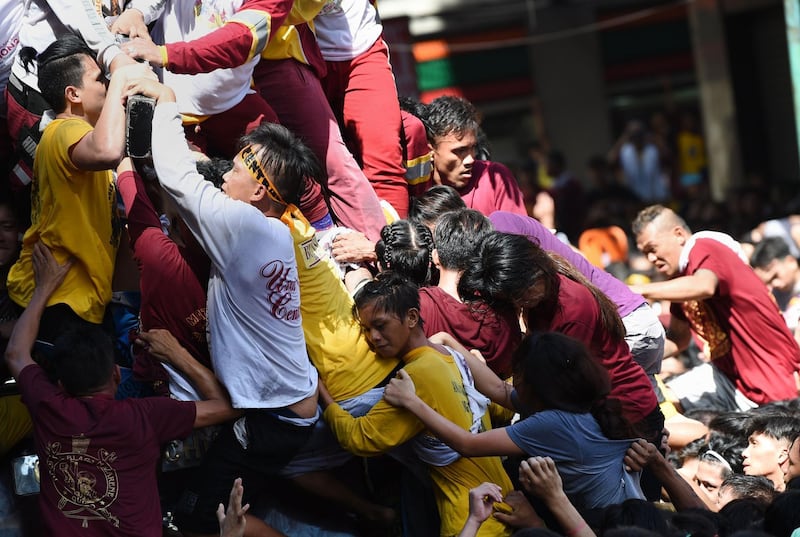 Catholic devotees jostle with each other as they try to touch the Black Nazarene. AFP