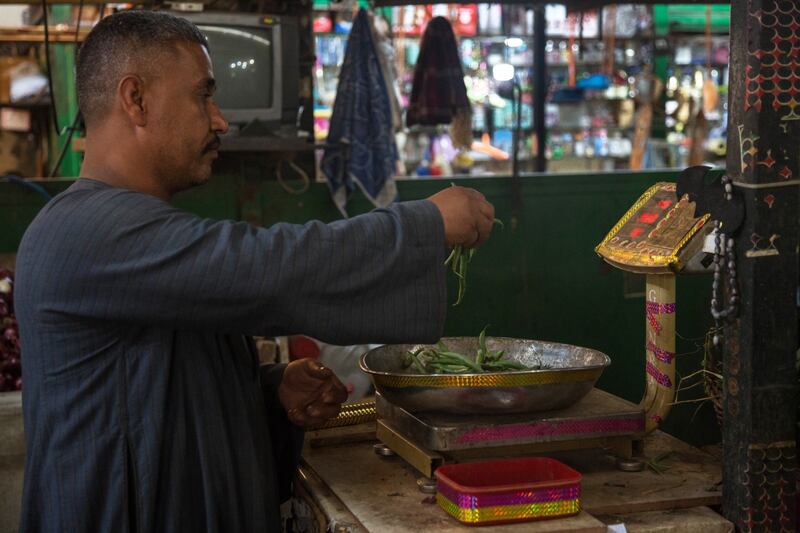 A vendor weighs vegetables at Al-Manhal market in Cairo. MaxAB serves small traditional retailers, which are the backbone of Egypt's grocery industry. Bloomberg