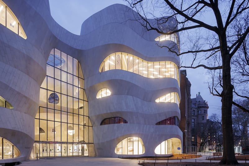 Spanning six storeys, the building features a towering atrium, uniquely-formed circular windows, fluidly-spread bridges and an overall biomorphic envelope