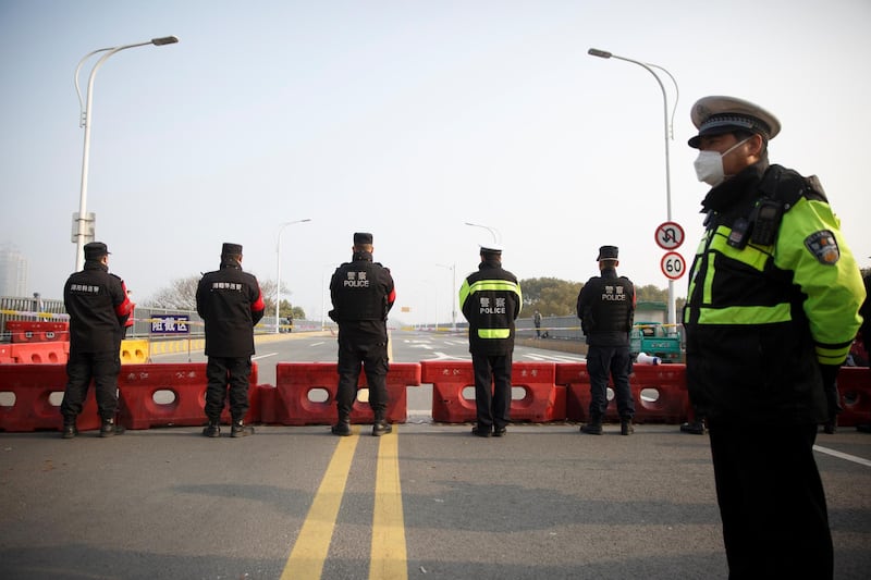 Police stand at a checkpoint at the Jiujiang Yangtze River Bridge that crosses from Hubei province into Jiujiang, Jiangxi province. Reuters