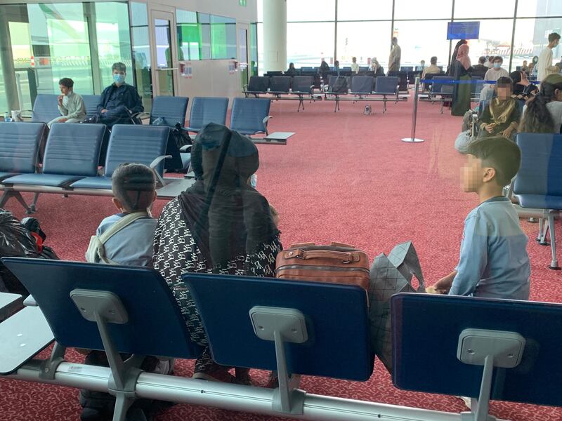 Passengers from the evacuation flight from Kabul wait to be processed at Al Maktoum International Airport.