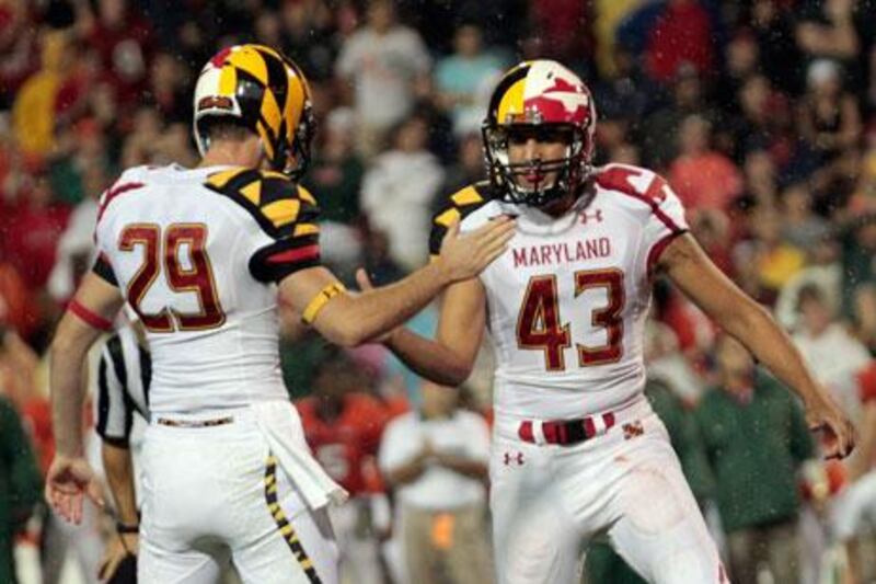 Maryland Terrapins' Michael Tart, No 29, celebrates a late fourth quarter field goal with kicker Nick Ferrara against the Miami Hurricanes at Byrd Stadium in College Park, Maryland, recently.