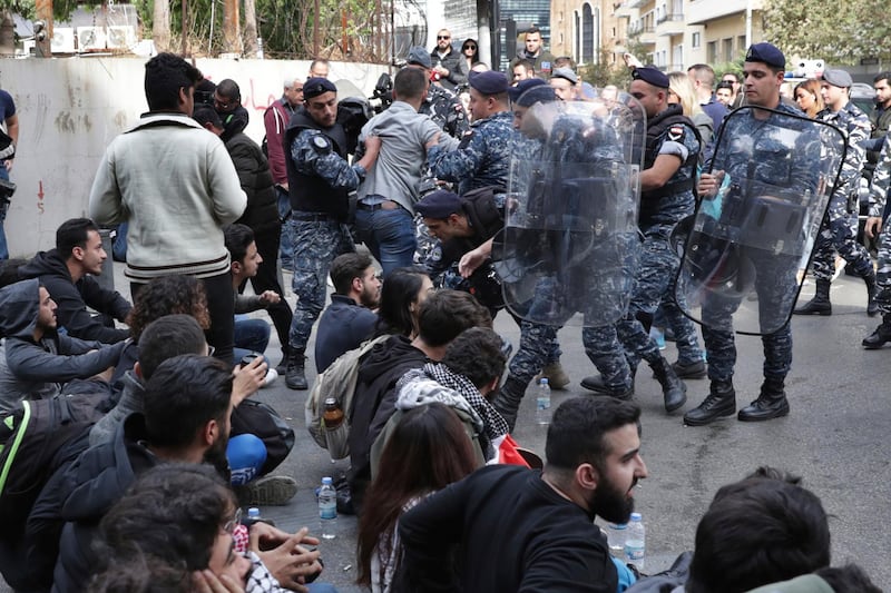 Riot police remove anti-government protesters blocking a road in Beirut, Lebanon. A key road has reopened in the Lebanese capital following clashes throughout the night between rival groups. The confrontations began when protesters blocked the street and were attacked by supporters of the two main Shiite political parties, Hezbollah and Amal. AP Photo