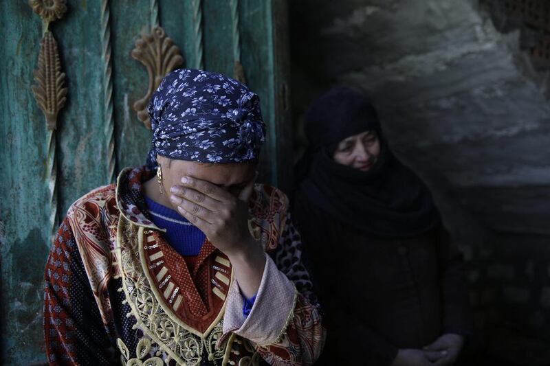 Family relatives of abducted Coptic Christian Samuel Walham weep outside their home in the Egyptian village of El Aour on February 14, 2015.Hassan Ammar/AP Photo