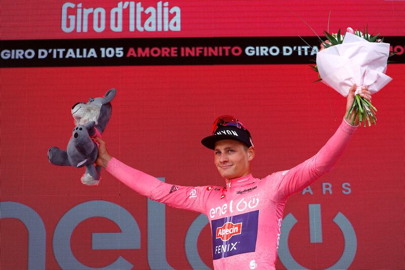 Mathieu van der Poel, wearing the overall leader's pink jersey, celebrates on the podium after winning the first stage of the Giro d'Italia. AFP