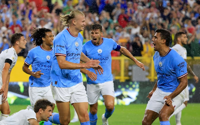 Erling Haaland celebrates with Rodri after scoring Manchester City's first goal. Getty
