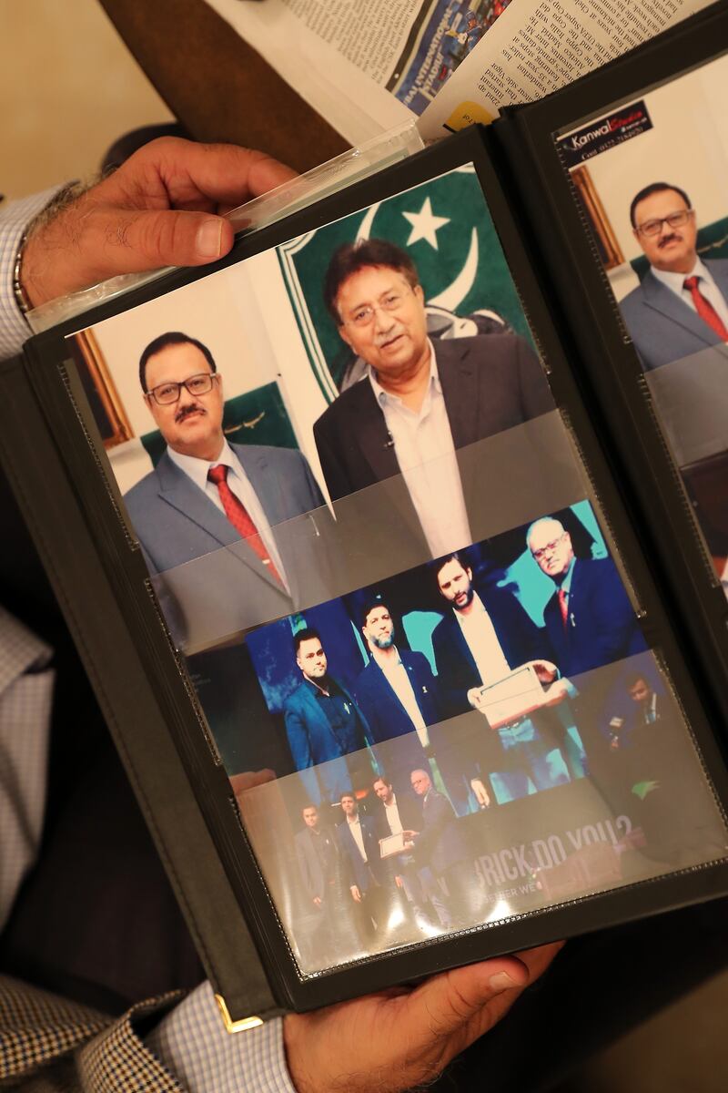 Shaukat shows an old photo of him with Pervez Musharraf, former president of Pakistan.