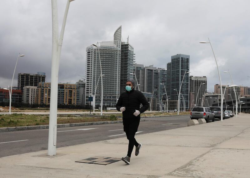 A man jogs along an empty road after Lebanon declared a medical state of emergency as part of the preventive measures against the spread of the coronavirus, in Beirut, Lebanon. Reuters