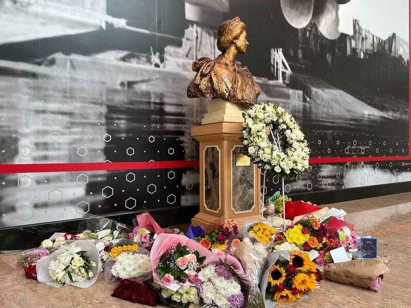 Flowers placed next to a bust of Britain's Queen Elizabeth II following the monarch's death in September 2022. Andrew Scott / The National