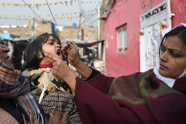 A Pakistani health worker administers polio vaccine drops to a child during a polio vaccination campaign in Islamabad in December, 2018. AFP    