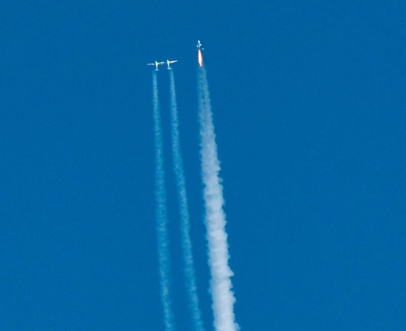 Virgin Galactic's SpaceshipTwo (R) launches for a suborbital test flight on December 13, 2018, in Mojave, California.   Virgin Galactic marked a major milestone on Thursday as its spaceship made it to a peak height, or apogee, of 51.4 miles (82.7 kilometers), after taking off attached to an airplane from Mojave, California, then firing its rocket motors to reach new heights.  / AFP / Gene Blevins
