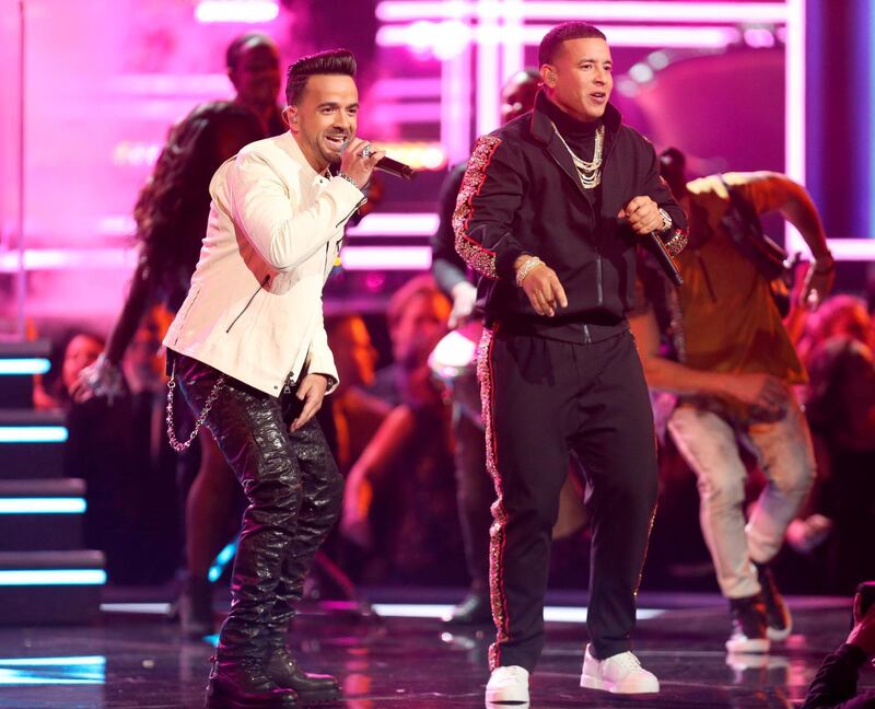 FILE - In this Jan. 28, 2018 file photo, Luis Fonsi, left, and Daddy Yankee perform "Despacito" at the 60th annual Grammy Awards in New York. â€œDespacitoâ€ and other popular music videos were the target of a security breach on the video sharing service Vevo. The cover image of the Luis Fonsi/Daddy Yankee hit was replaced by an image of masked people pointing guns. Clips by Taylor Swift, Drake, Selena Gomez and Shakira also were affected. A YouTube spokesperson says the company worked with its partner to disable access after seeing â€œunusual upload activityâ€ on some Vevo channels. (Photo by Matt Sayles/Invision/AP, File)