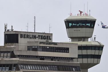 The control tower (R) of Tegel Airport (TXL) is pictured in Berlin on October 14, 2020 as an aircraft of airline SunExpress takes off. Berlin's new international airport BER, which will be the only major airport for the Berlin Brandenburg region, is planned to open on October 31, 2020. Berlin's airport Tegel will close on November 8, 2020 following the takeoff of an Air France flight to Paris. / AFP / John MACDOUGALL