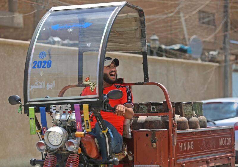 Gas cylinder delivery man Mountazar Abbas sings from his rickshaw to announce his arrival in the Karrada district of Baghdad. AFP