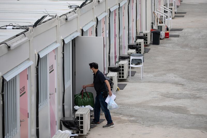 A patient enters his cabin at the San Tin Community Isolation Facility. Photo: EPA