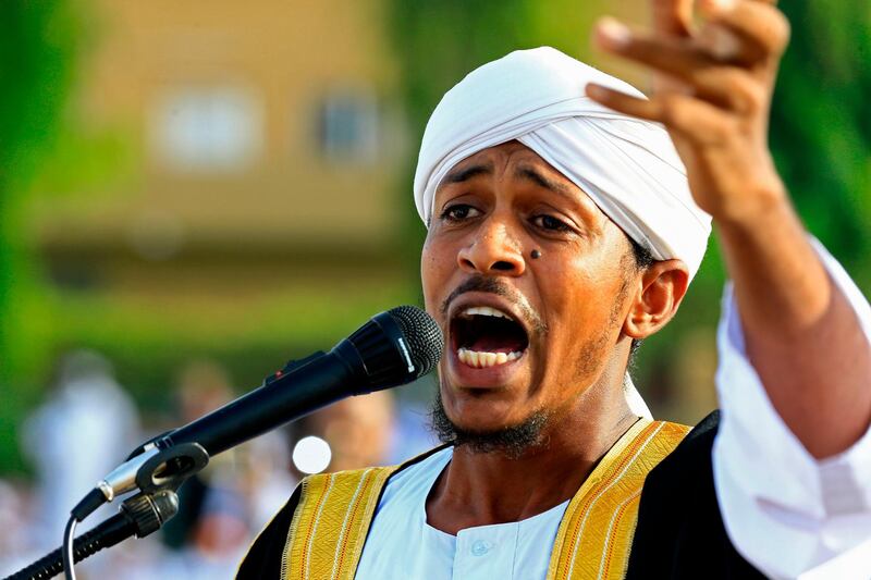 An Imam preaches a sermon to worshippers during Eid Al Fitr prayers in the district of Jureif Gharb of Sudan's capital Khartoum AFP