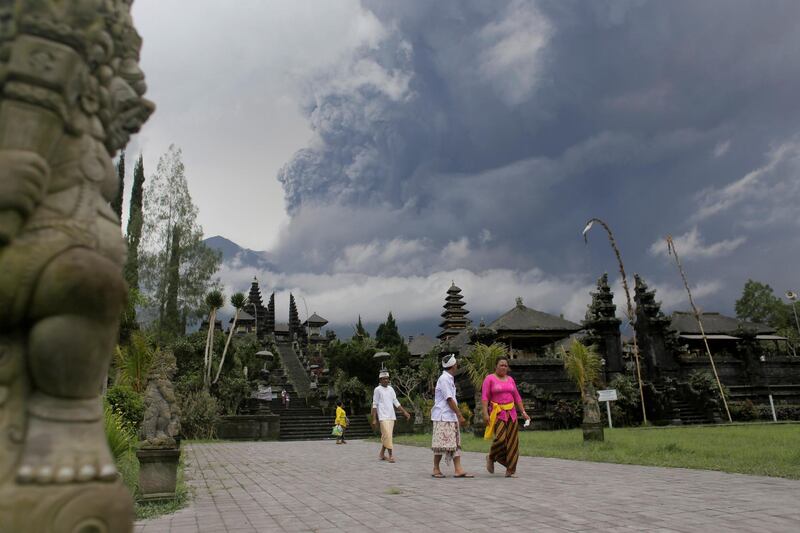 Balinese Hindus walk after praying as Mount Agung volcano erupts at Besakih Temple in Karangasem, Bali, Indonesia. Johannes P. Christo / Reuters