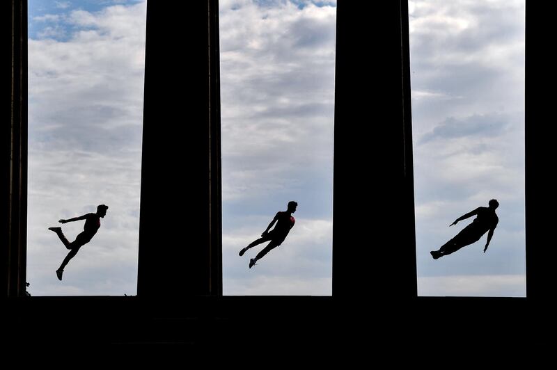 Beren DAmico, Louis Gift and Charlie Wheeler perform acrobatics from their festival show on Calton Hill in Edinburgh, Scotland. Getty