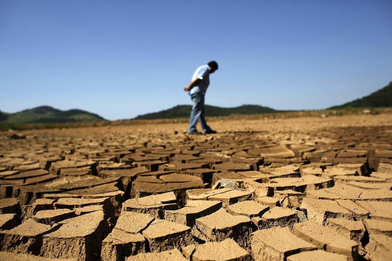 A government worker surveys the cracked ground of Jaguari dam, which is part of the Cantareira reservoir in Sao Paulo. Brazil on January 2014 saw the driest summer on record in Sao Paulo. Roosevelt Cassio / Reuters