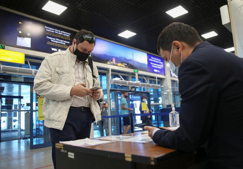 A man uses the Ashyq mobile application at a security checkpoint in the international airport of Almaty, Kazakhstan. Reuters